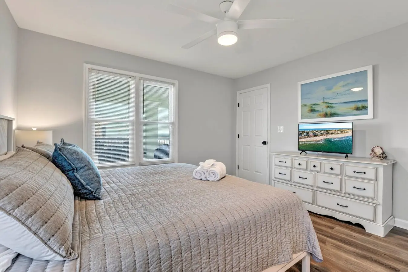 This master bedroom is basically the coastal retreat of your dreams—serene, spacious, and with those ocean views and sliding glass doors that make waking up feel like pure luxury.