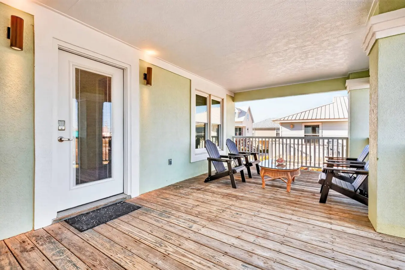 Spend your days lounging on this sprawling covered deck with those perfect Adirondack chairs facing the ocean—it's the kind of spot where time just stops and the view does all the talking.