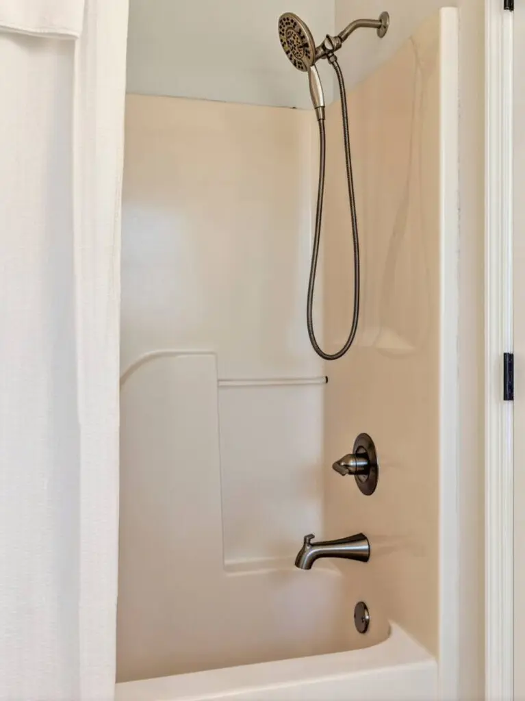 This bright, updated bathroom with its clean fixtures and walk-in shower is ready to rinse off the salt and sand so you can jump right back into your beach day.