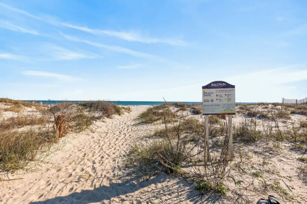 Step over the dunes and straight onto the sand from this perfectly positioned beachfront home, where that well-worn path is basically your daily invitation to endless ocean views and seaside adventures.