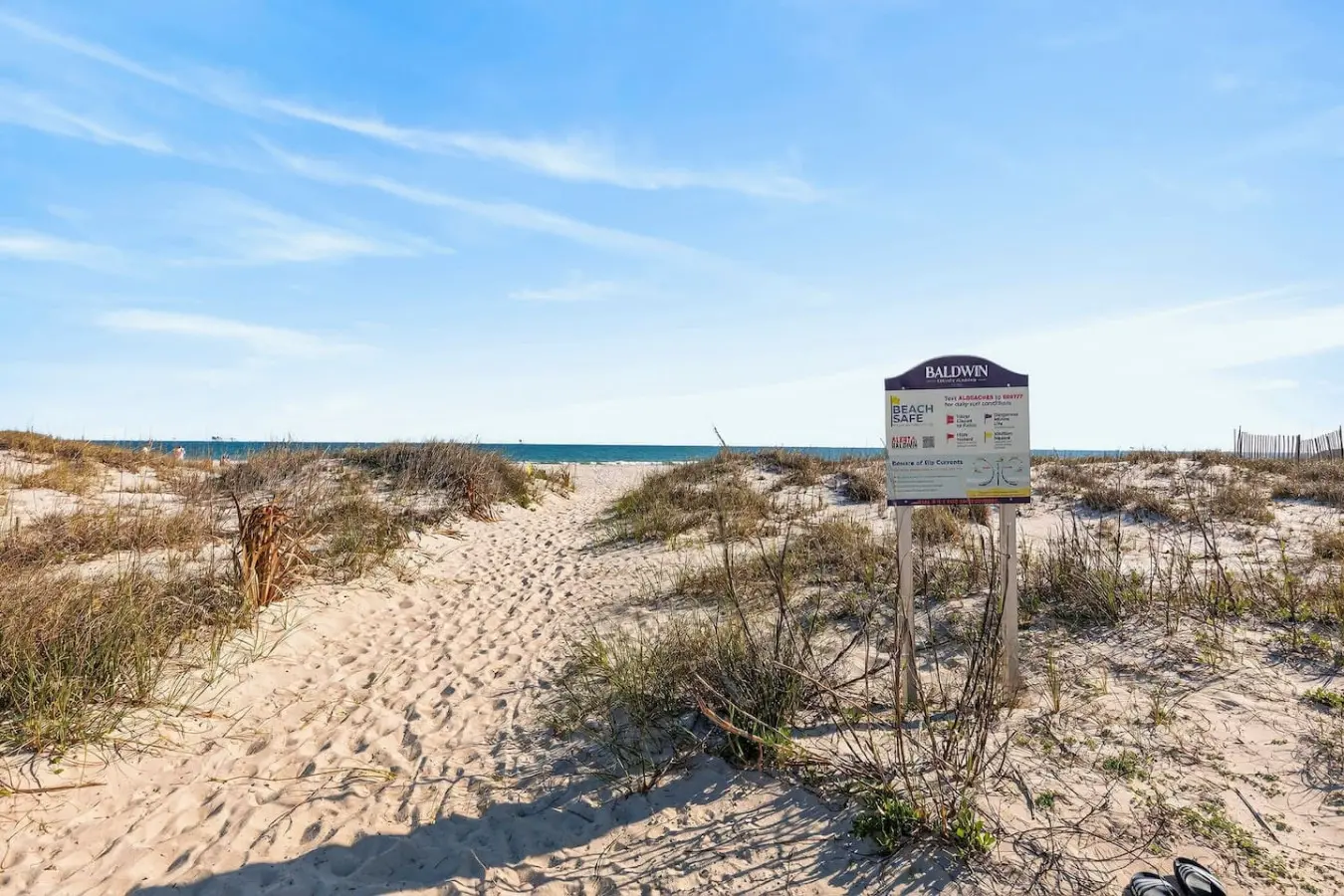 Step over the dunes and straight onto the sand from this perfectly positioned beachfront home, where that well-worn path is basically your daily invitation to endless ocean views and seaside adventures.