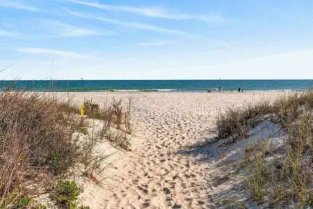 Step right over the dunes and onto the sand—this is the kind of beachfront spot where you're literally seconds away from the waves and everything that makes a coastal getaway feel like home.