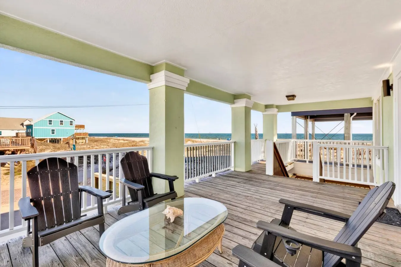 Imagine spending your entire beach vacation on this sprawling covered deck—multiple lounge spots, unobstructed ocean views, and that perfect coastal breeze that makes you never want to go inside.