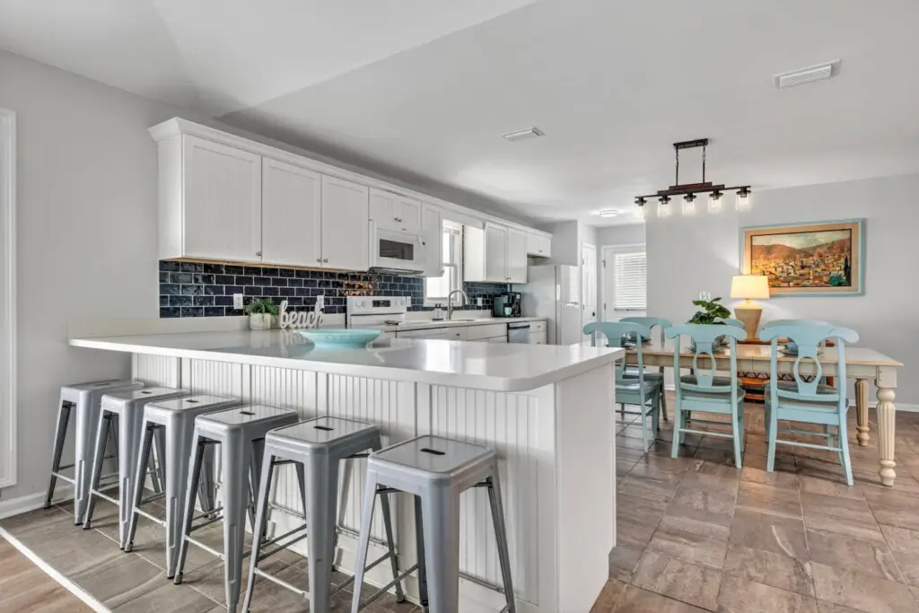 Gather the whole crew around this bright, airy kitchen island where cooking and hanging out blend seamlessly together, then slide right over to that charming dining area for meals with a view.