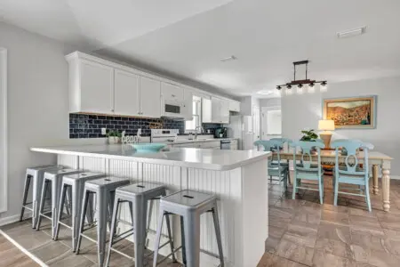 Gather the whole crew around this bright, airy kitchen island where cooking and hanging out blend seamlessly together, then slide right over to that charming dining area for meals with a view.