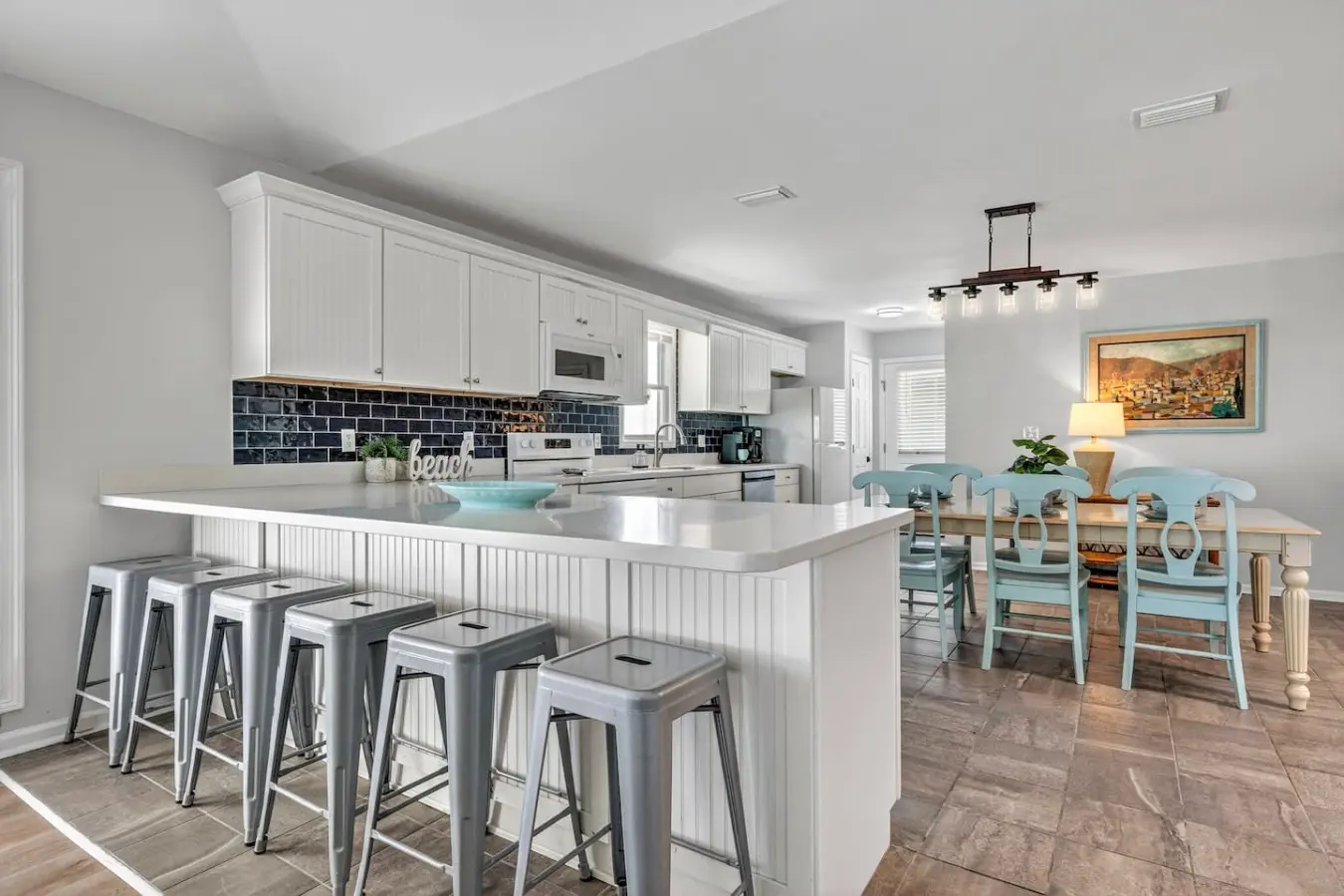 Gather the whole crew around this bright, airy kitchen island where cooking and hanging out blend seamlessly together, then slide right over to that charming dining area for meals with a view.