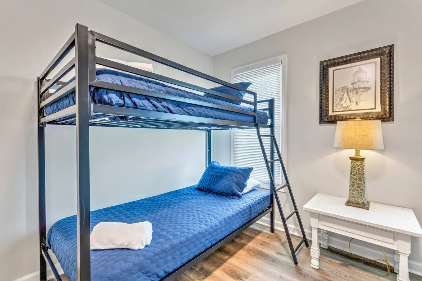 This bright bunkroom with its sturdy metal bunks and blue bedding is perfect for keeping the whole crew comfortable and close together during your beach getaway.
