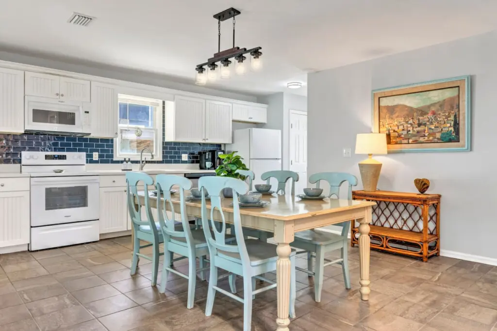 This spacious, light-filled kitchen and dining area is where all the magic happens—plenty of counter space for cooking together, comfortable seating for the whole crew, and that breezy coastal flow that makes every meal feel special.