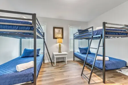 Perfect for families or friend groups, this spacious bunkroom sleeps everyone comfortably with its four cozy beds and bright, airy setup that keeps the whole crew happy under one roof.