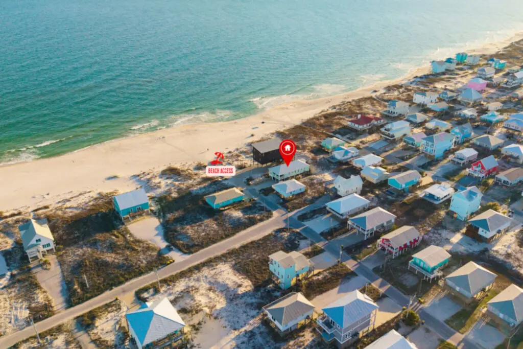 Perched right on the sand with colorful beach cottages dotting the shoreline, this is the kind of elevated beachfront spot where you've got direct access to the water and that perfect bird's-eye view of everything coastal life has to offer.
