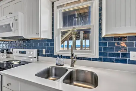 Cook up your favorite meals in this bright, updated kitchen, then gaze out at the ocean views while you wash the dishes—basically the best reward after a day in the sand.