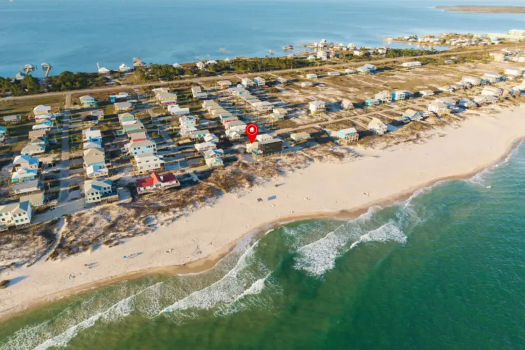 Imagine waking up in this colorful beachfront community where your home sits elevated right above the sand, giving you that perfect mix of privacy and direct beach access that makes every day feel like a coastal dream.