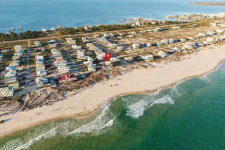 Imagine waking up in this colorful beachfront community where your home sits elevated right above the sand, giving you that perfect mix of privacy and direct beach access that makes every day feel like a coastal dream.