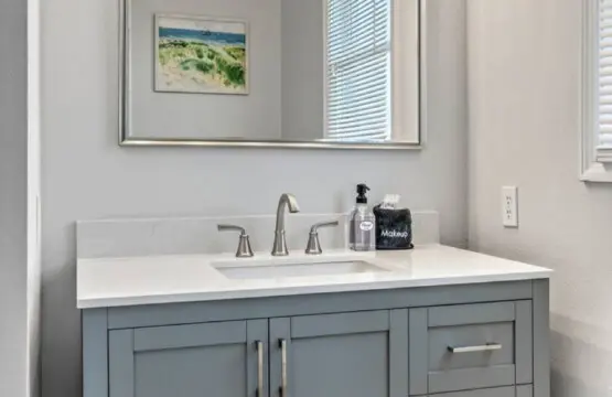 This fresh, bright bathroom with its elegant vanity and beautiful lighting is the perfect spot to freshen up between beach days.