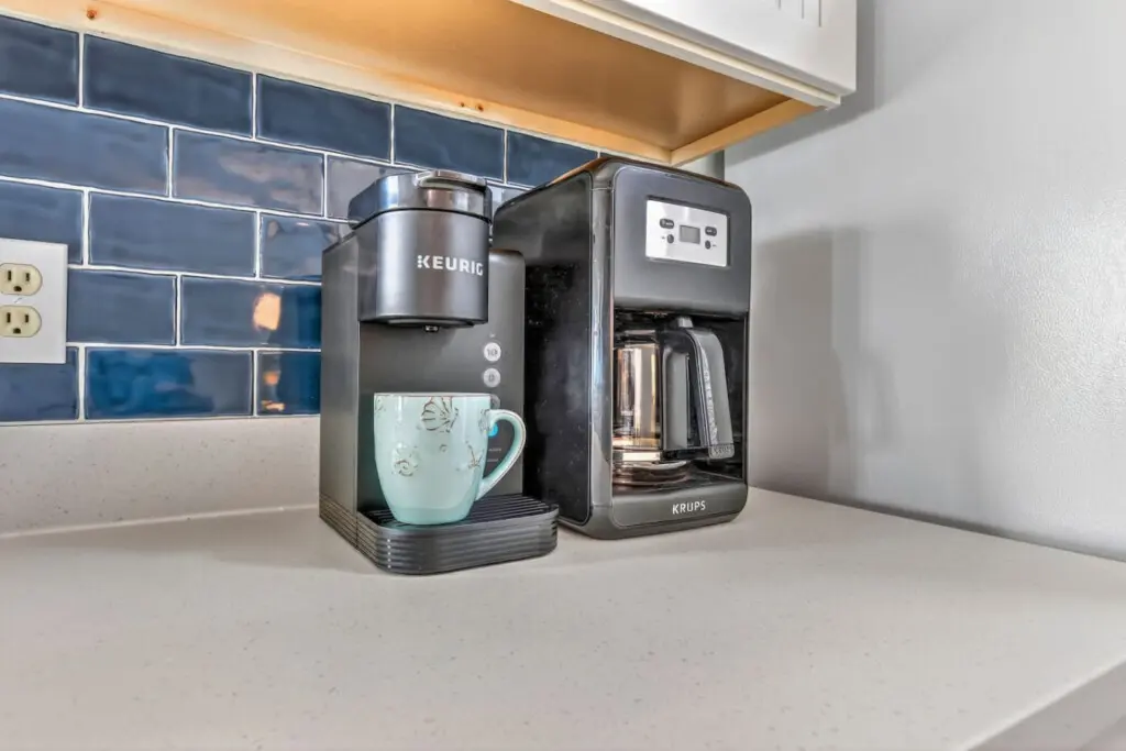 Brew your morning coffee with a view in this charming kitchen setup where everything you need for the perfect beach day is just steps away.