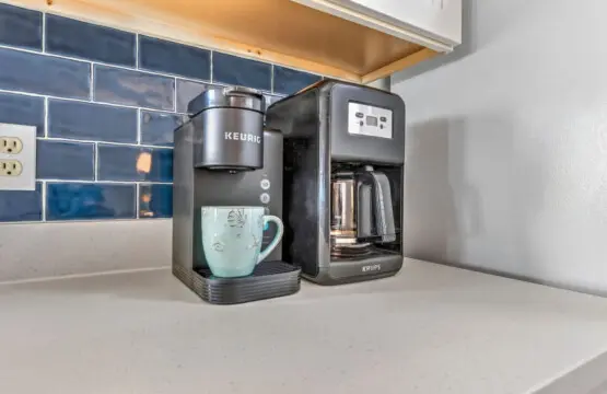Brew your morning coffee with a view in this charming kitchen setup where everything you need for the perfect beach day is just steps away.