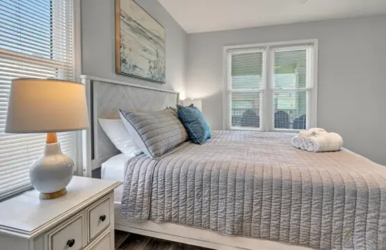 This serene bedroom nails the whole coastal escape thing—soft linens, natural light pouring in through those shutters, and all the calm vibes you need to actually sleep in past sunrise.