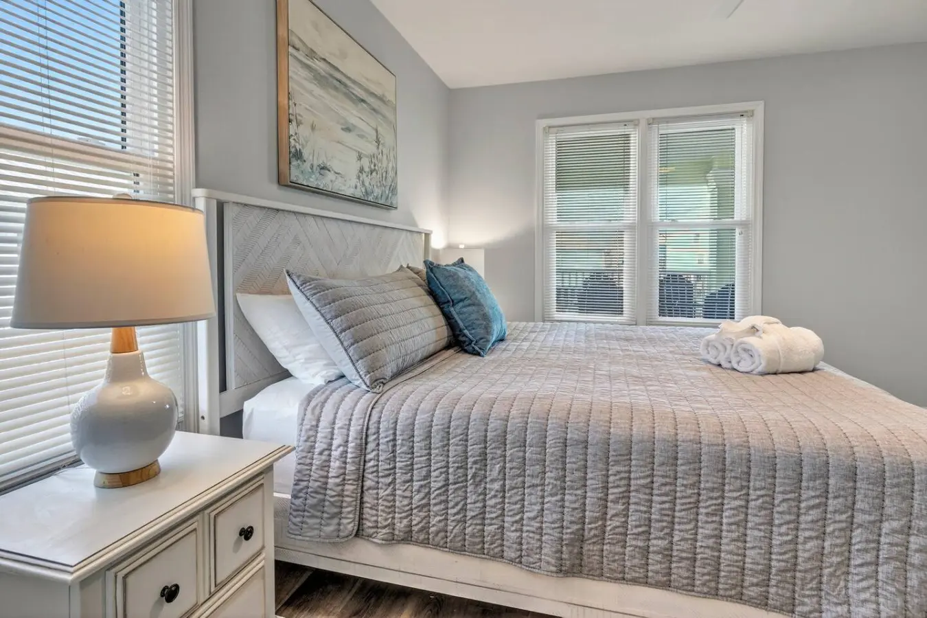 This serene bedroom nails the whole coastal escape thing—soft linens, natural light pouring in through those shutters, and all the calm vibes you need to actually sleep in past sunrise.