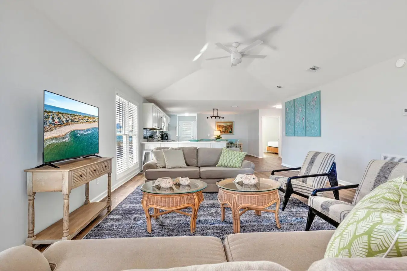 This spacious open-concept living room is basically made for those lazy beach days—tons of natural light, comfy seating for the whole crew, and easy flow straight to the kitchen whenever the mood strikes.