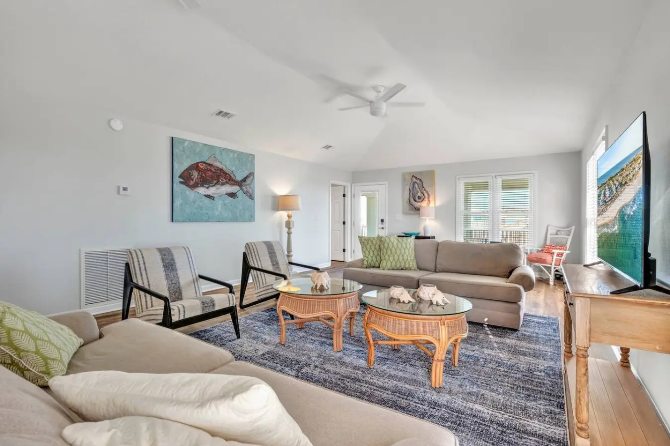 Gather everyone in this spacious, light-filled living room where the open layout and multiple seating areas make it easy to hang out together while still having your own cozy corner to chill out in.