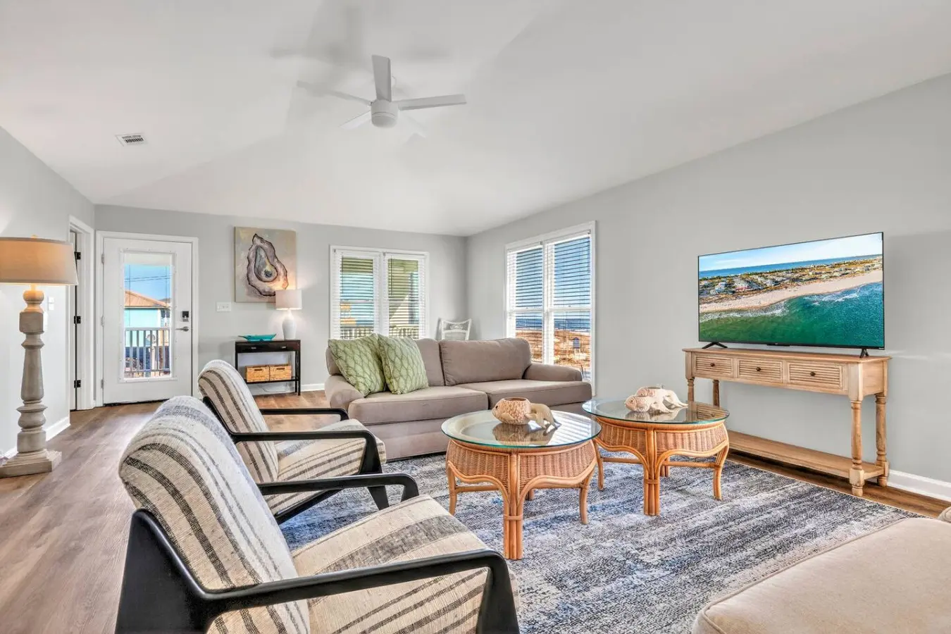 Settle into this bright, airy beachfront living room with ocean views framed perfectly from every angle—it's basically your personal seaside sanctuary with all the comfort and space to truly unwind.