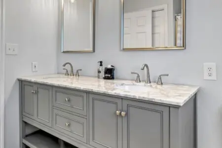This spa-like master bath proves that even the details matter—double vanities, marble countertops, elegant lighting, and those gorgeous mirrors set the tone for starting and ending each day in style.