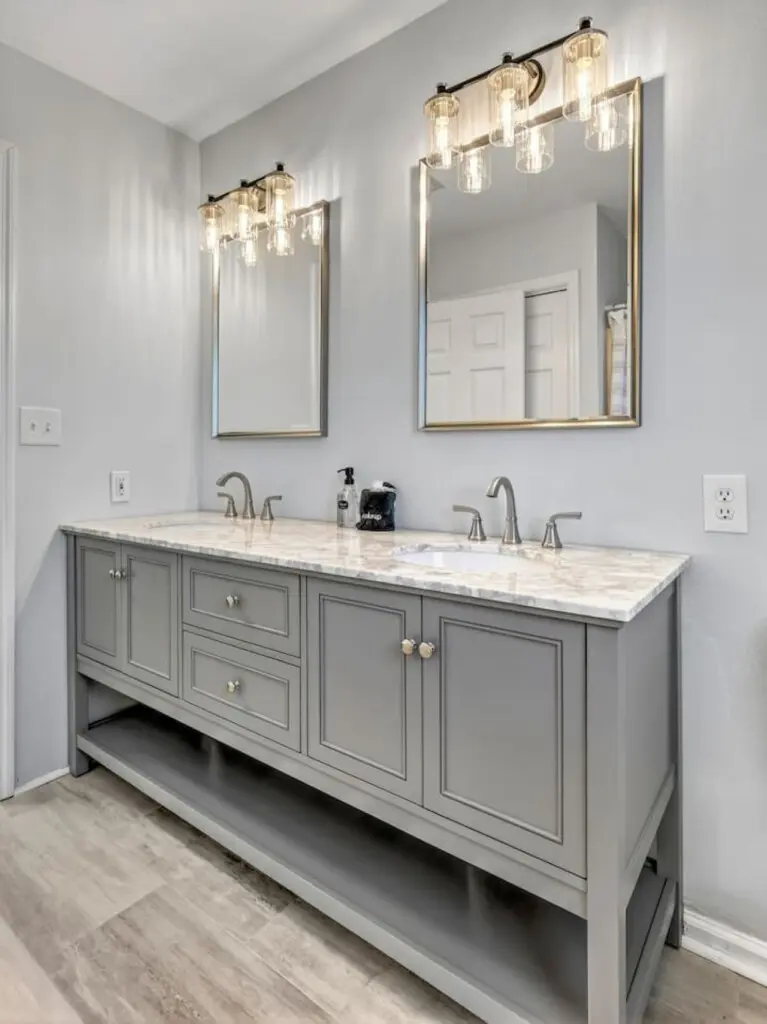 This spa-like master bath proves that even the details matter—double vanities, marble countertops, elegant lighting, and those gorgeous mirrors set the tone for starting and ending each day in style.