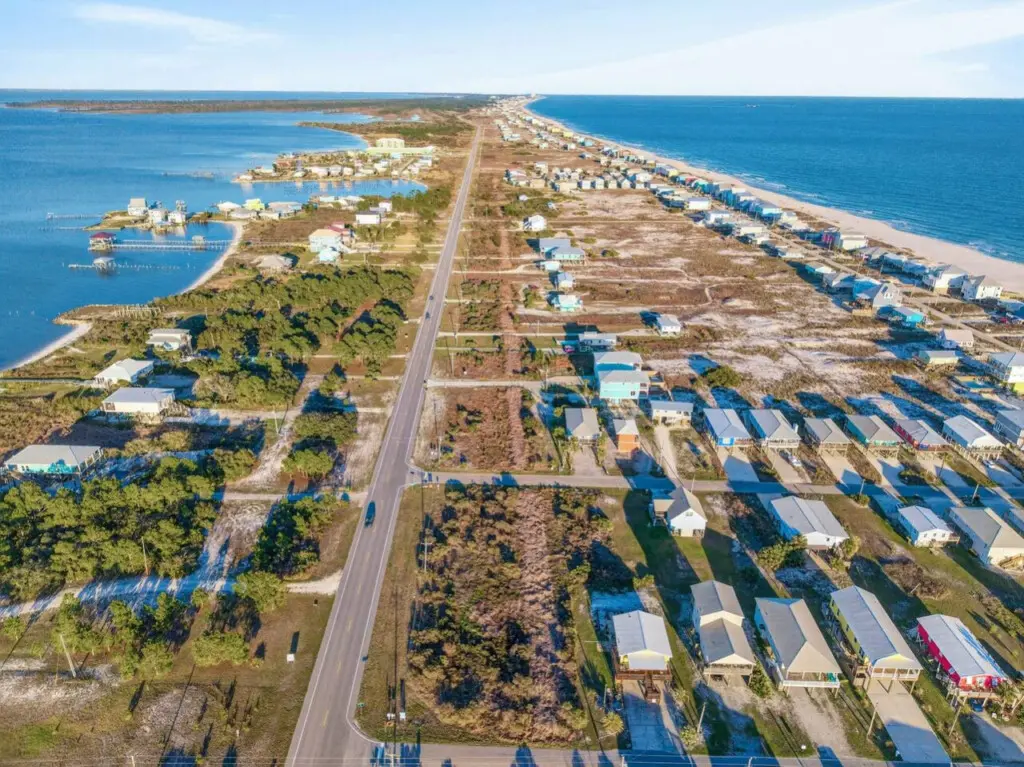 Picture yourself living right in the middle of this vibrant beachfront community—your own elevated sanctuary with direct sand access, endless ocean views, and that perfect bird's-eye perspective of the colorful beach life unfolding all around you.