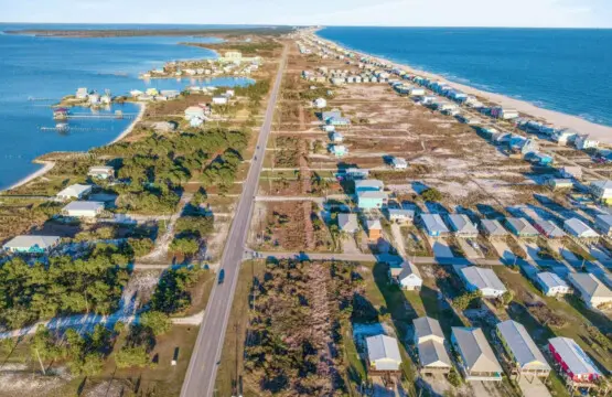 Picture yourself living right in the middle of this vibrant beachfront community—your own elevated sanctuary with direct sand access, endless ocean views, and that perfect bird's-eye perspective of the colorful beach life unfolding all around you.