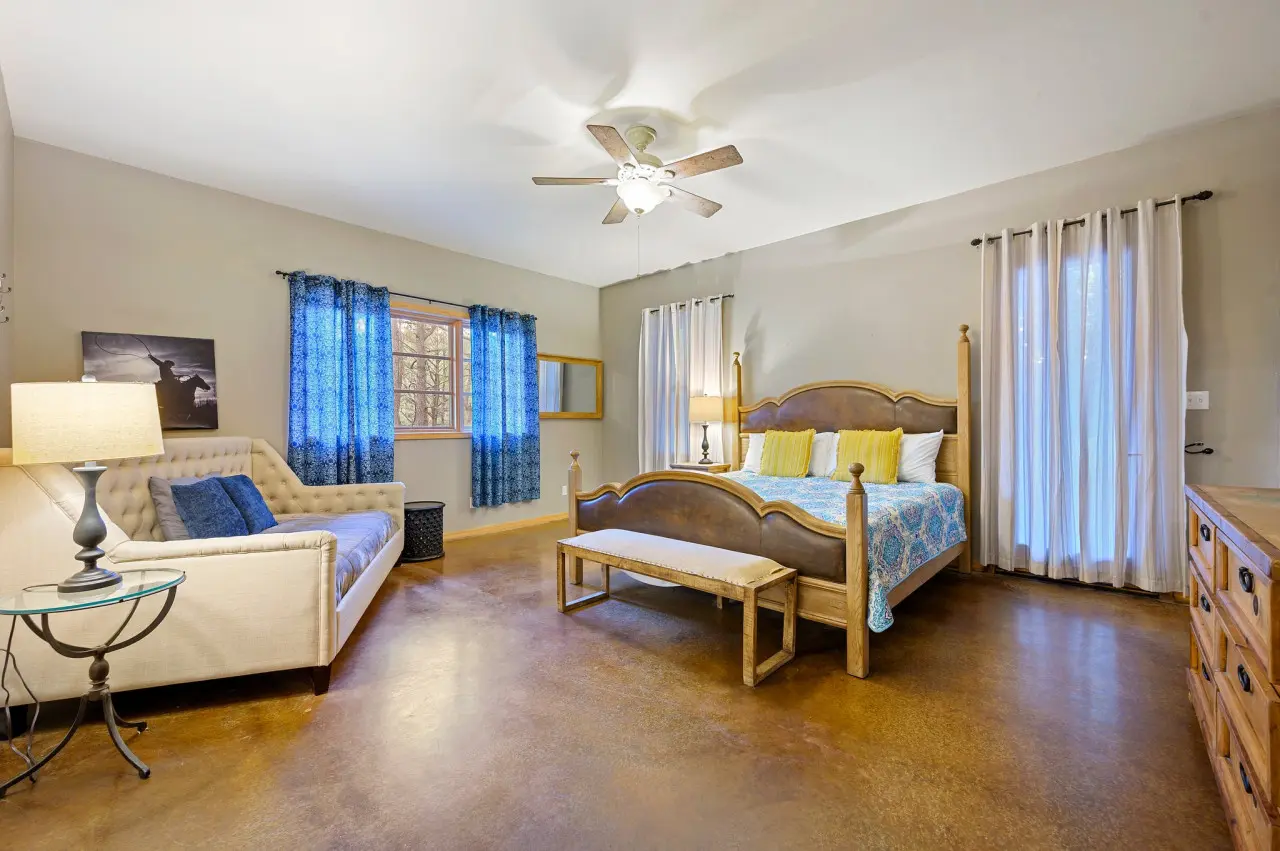 Comfort meets versatility: Enjoy the added convenience of a plush couch in our cabin bedroom, offering a cozy retreat for relaxation and leisure.