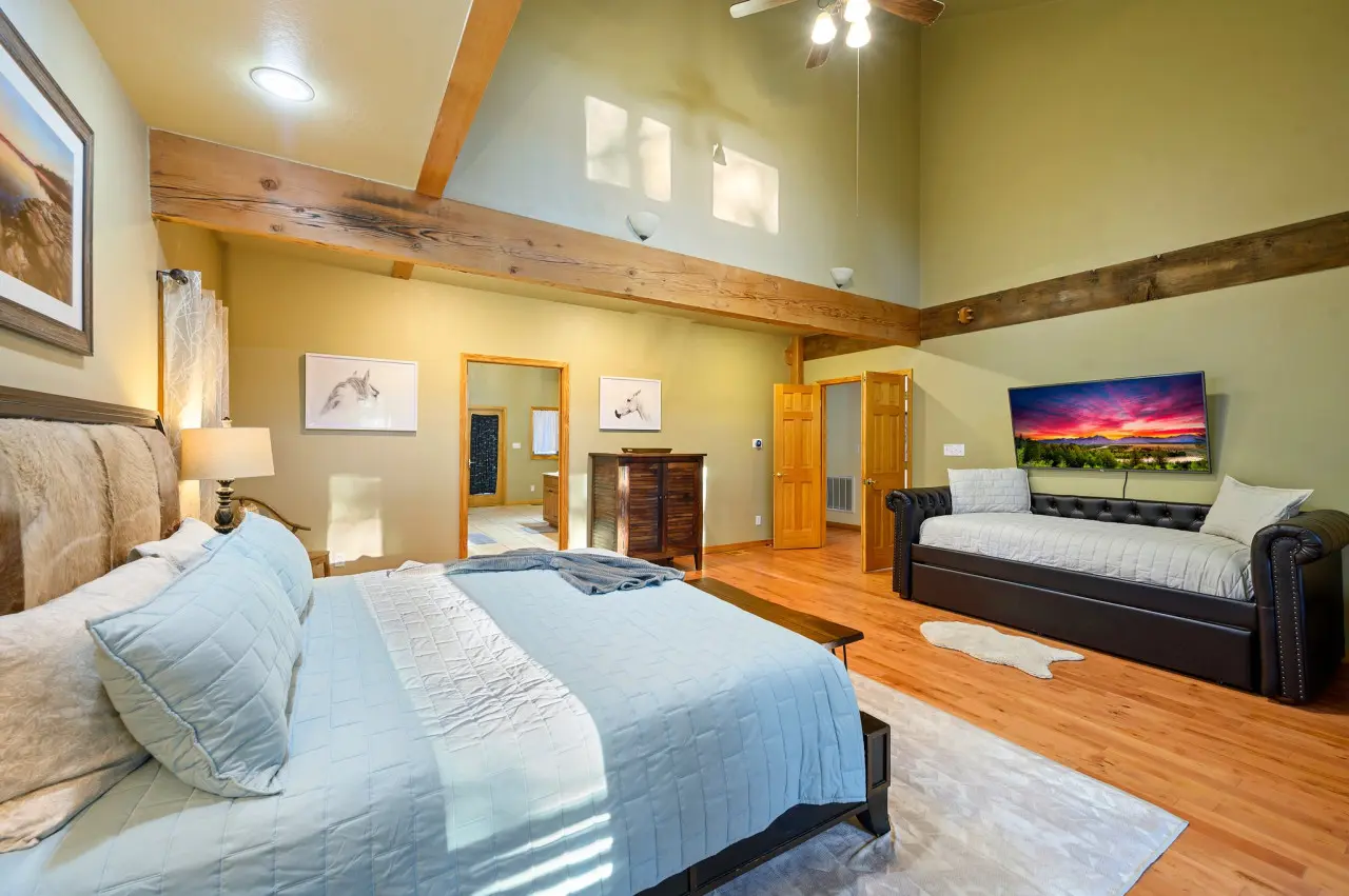 Indulge in the comfort of our cabin bedroom, where a plush couch and television provide the perfect setting for rest and relaxation.