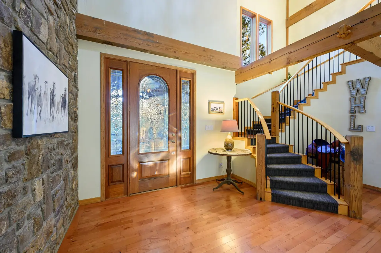 Our cabin's entrance beckons with the promise of cozy comforts and scenic views, while the stairs lead you to a haven of relaxation and rustic charm.