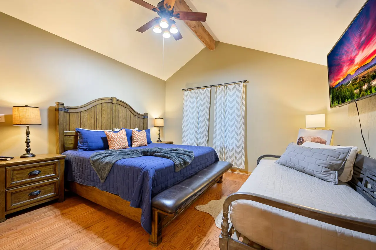 Unwind in style in our cabin bedroom, where a comfortable couch and television offer the perfect retreat after a day of exploration and adventure