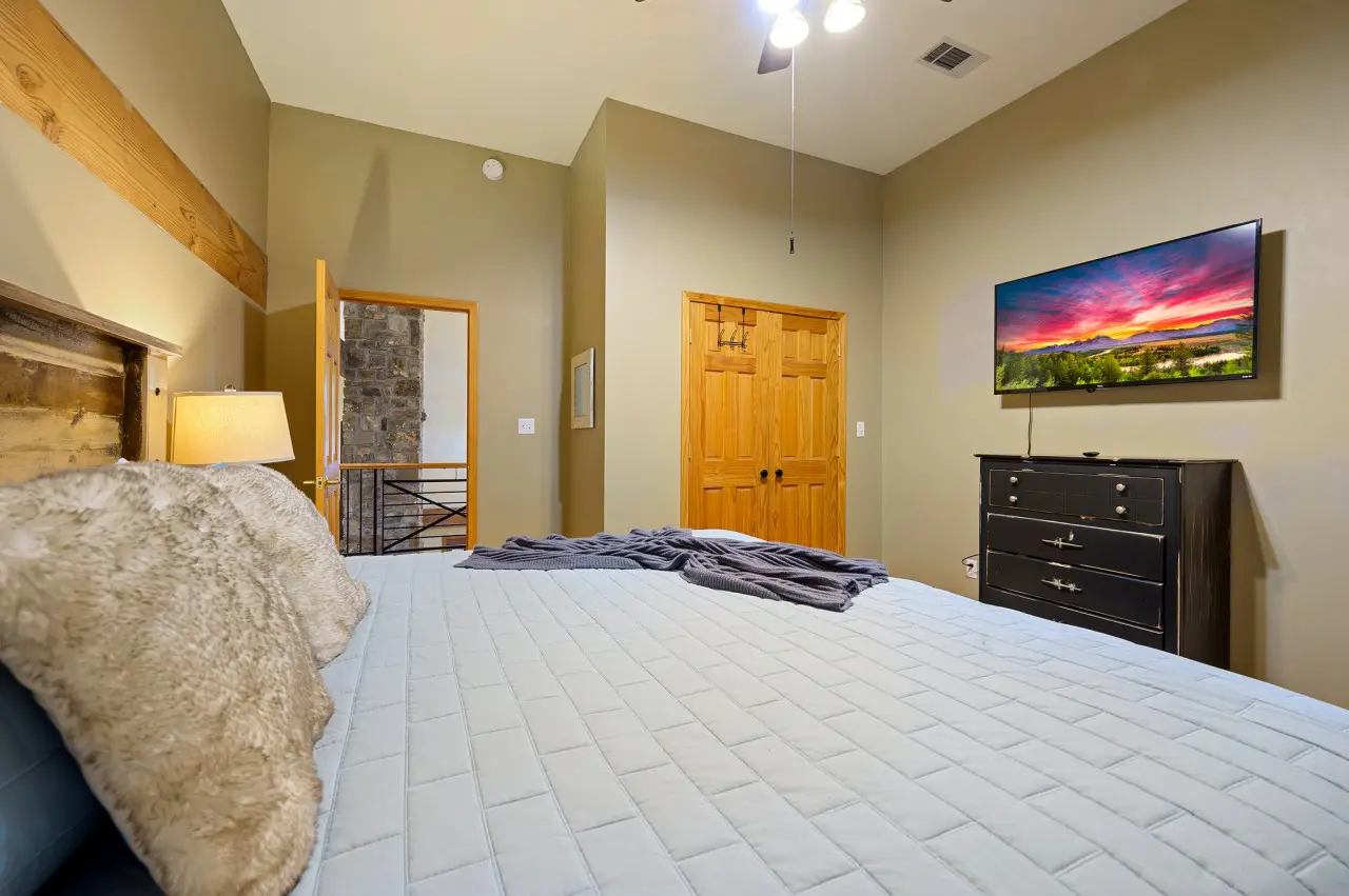 Unwind in our cabin bedroom, complete with modern amenities like a television for ultimate relaxation and entertainment.