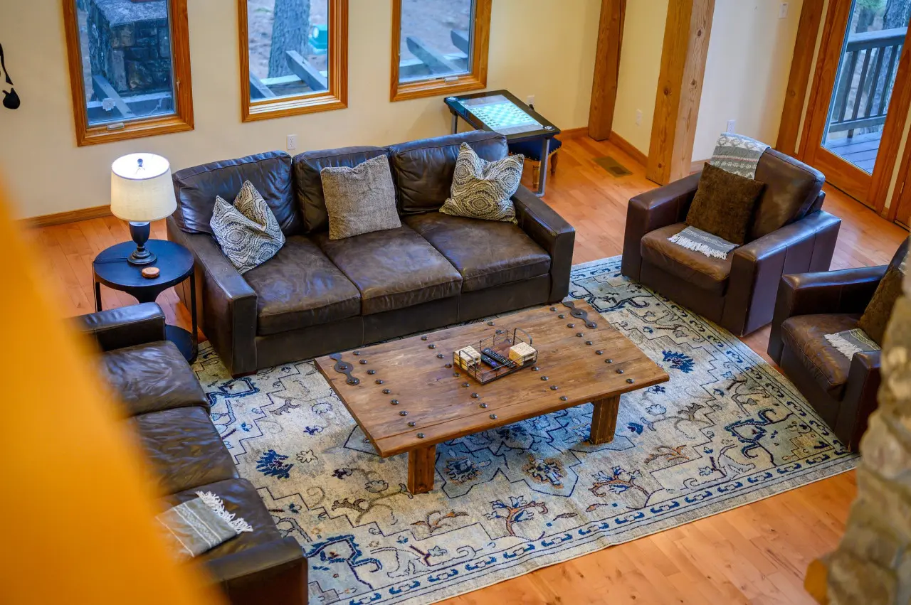 This living room is a cozy haven, where plush seating and warm ambiance invite relaxation, laughter, and unforgettable moments.
