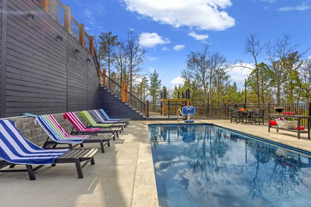Colorful towels on the loungers, a pool basketball hoop, and a playground in the back—this setup was made for big groups.