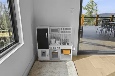 Little ones can whip up imaginary meals in the play kitchen while you keep an eye on them from the deck.