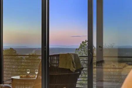 That hazy Broken Bow view at golden hour from the balcony — this is peak relaxation.