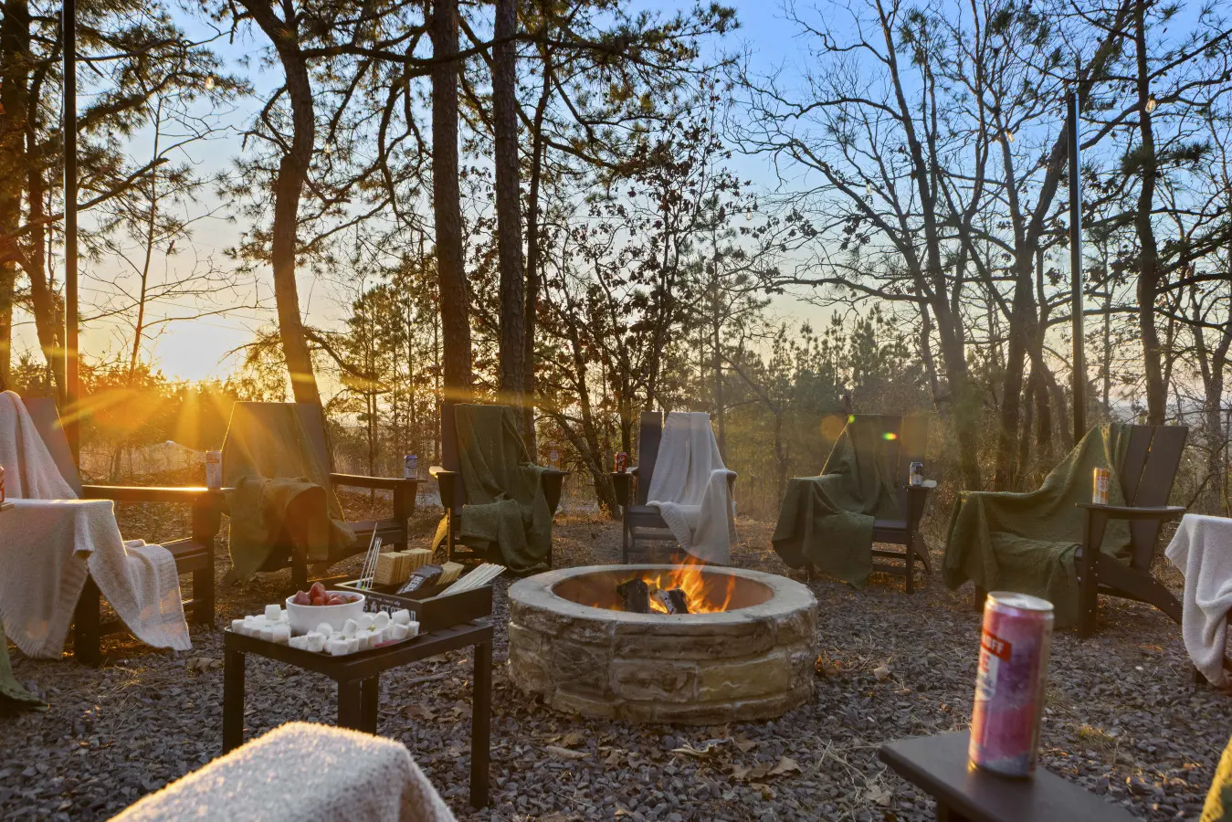 S'mores setup at sunset with blankets draped over every chair—this fire pit area knows what it's doing.