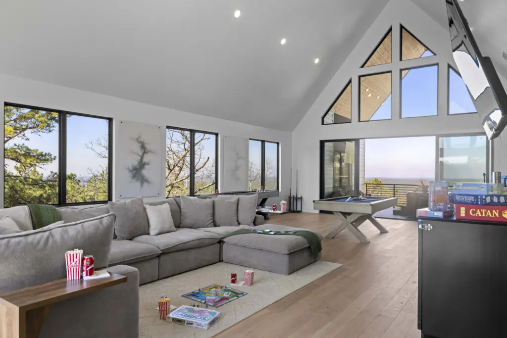 Game night sorted with Catan, a pool table, and that massive sectional—plus views for days through those A-frame windows.