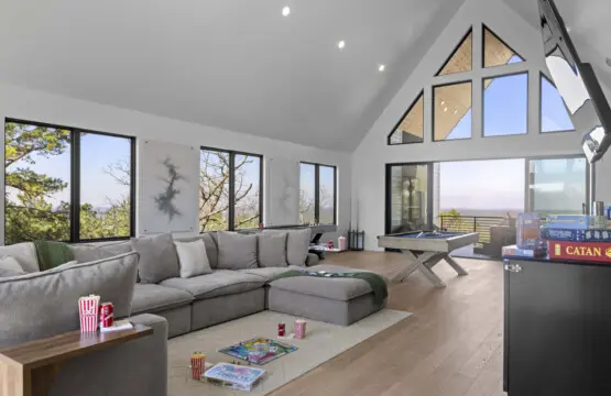 Game night sorted with Catan, a pool table, and that massive sectional—plus views for days through those A-frame windows.