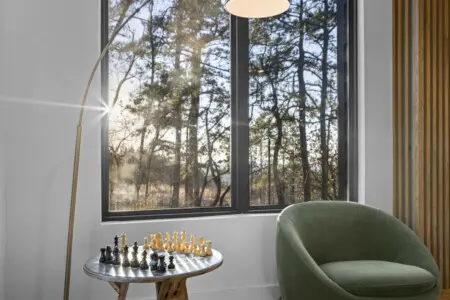 A quiet corner for your next chess match, with sunlight streaming through the pines and a velvet chair to sink into.