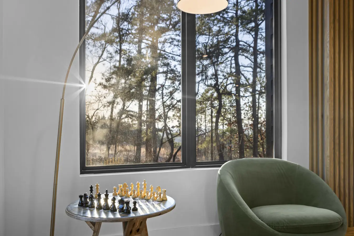 A quiet corner for your next chess match, with sunlight streaming through the pines and a velvet chair to sink into.