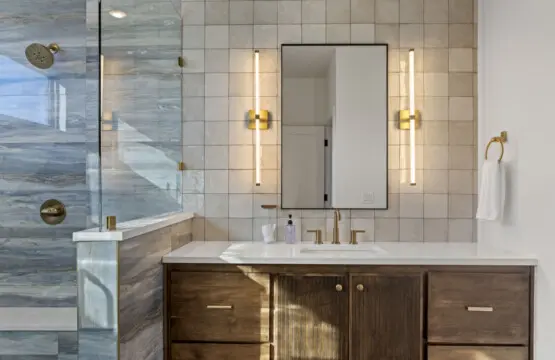 The brushed gold fixtures and those sleek sconces give this bathroom a boutique hotel feel.