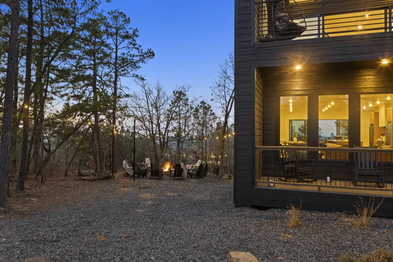 The fire pit's glowing and the house is all lit up—this is when Eagle's Vista really comes alive at dusk.