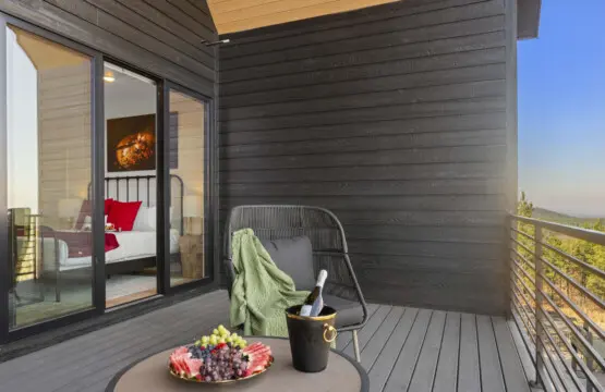 This bedroom deck looks out over the pines — made for slow mornings and doing absolutely nothing.