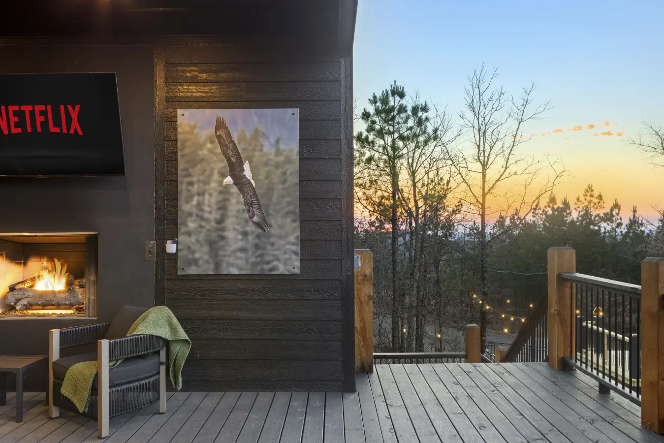Outdoor fireplace, Netflix on the TV, and a bald eagle print—because the deck vibes at Eagle's Vista stay cozy after sunset.