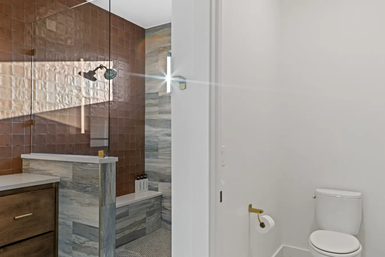 This master bath features a spacious walk-in shower with premium tile, dual vanities, and stunning natural light.