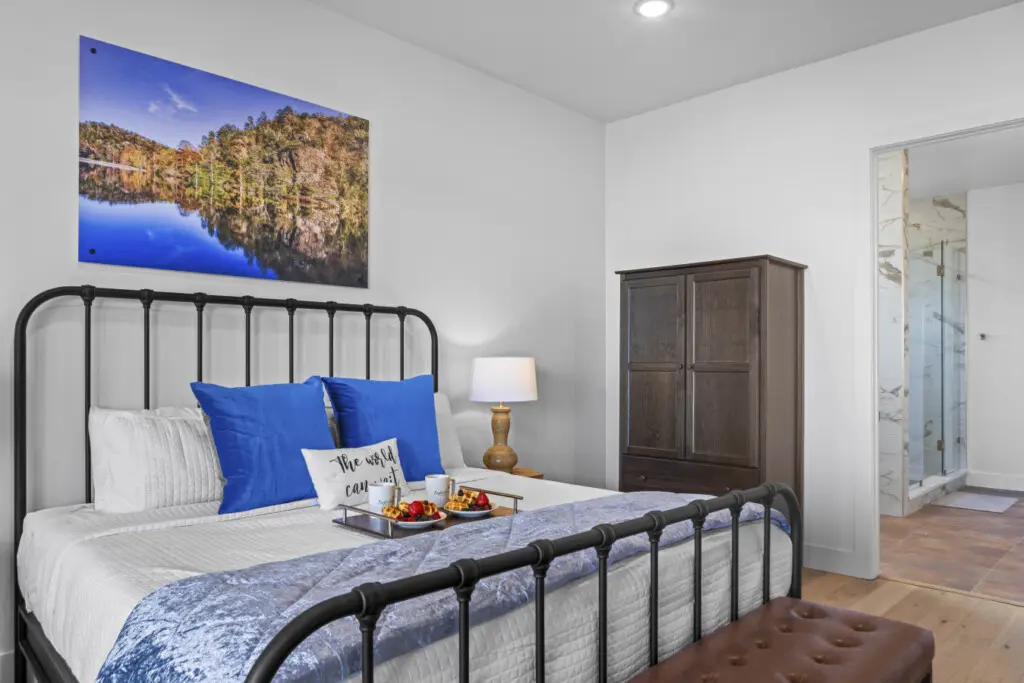 Wake up to stunning lake views from your cozy master bedroom with that gorgeous metal bed frame.