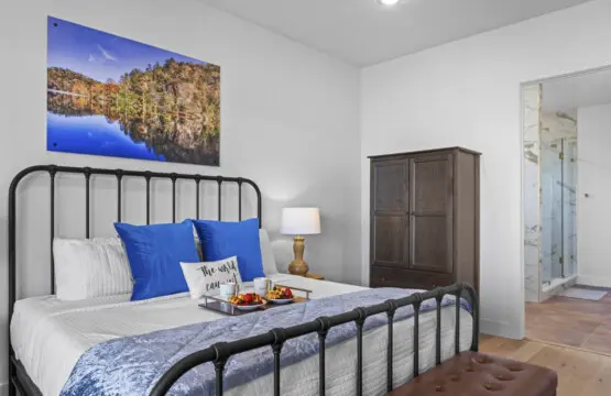 Wake up to stunning lake views from your cozy master bedroom with that gorgeous metal bed frame.